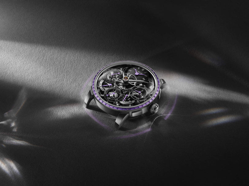 Luxury watch with intricate design on a dark fabric background