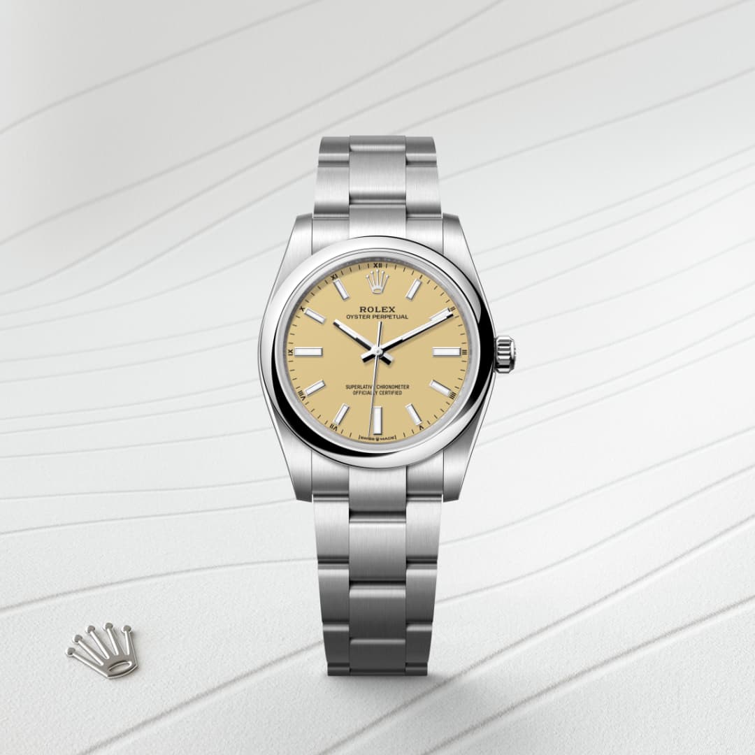 A silver Rolex watch with a beige dial is displayed on a light, textured background with a small crown emblem.