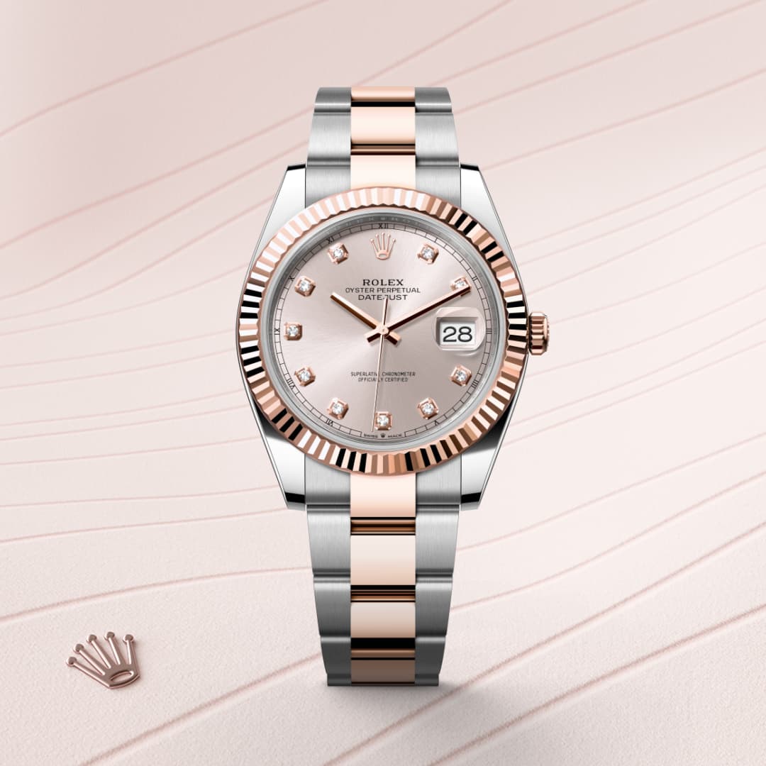 A two-tone Rolex wristwatch with a diamond dial and date display, set against a light patterned background.