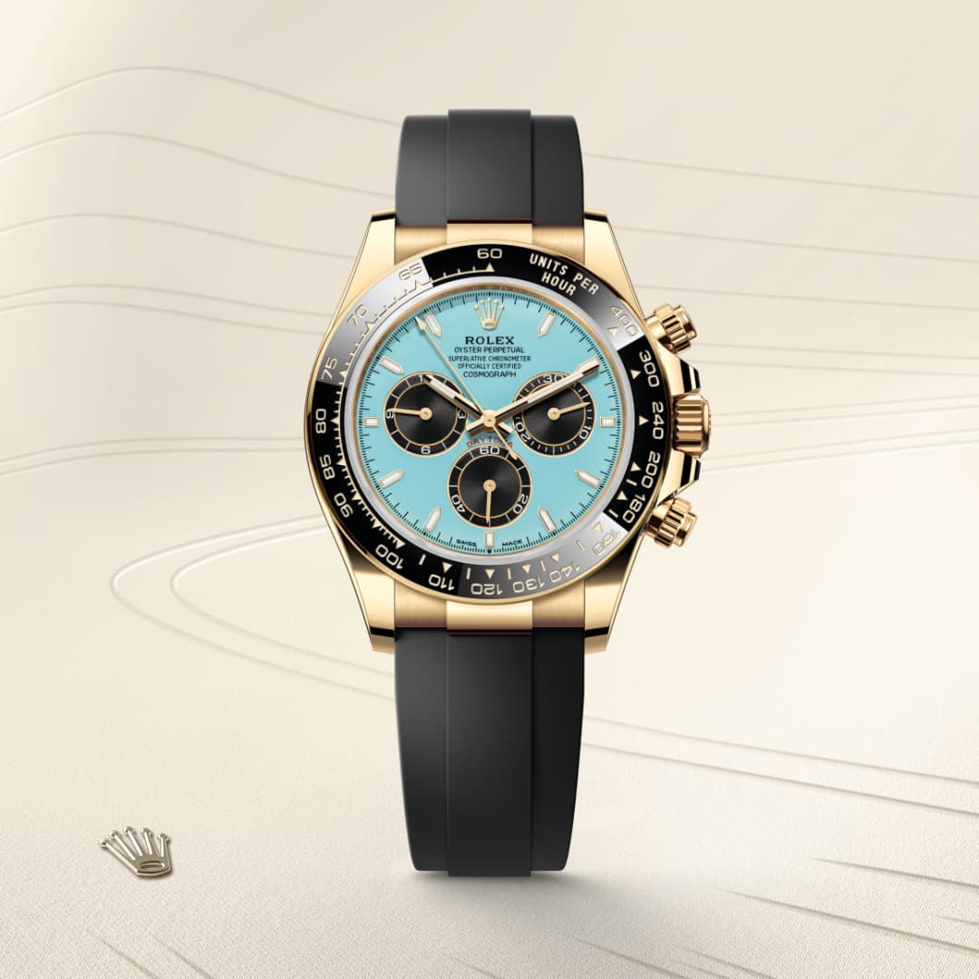 A gold Rolex watch with a turquoise face and black strap displayed on a beige background with a crown logo.