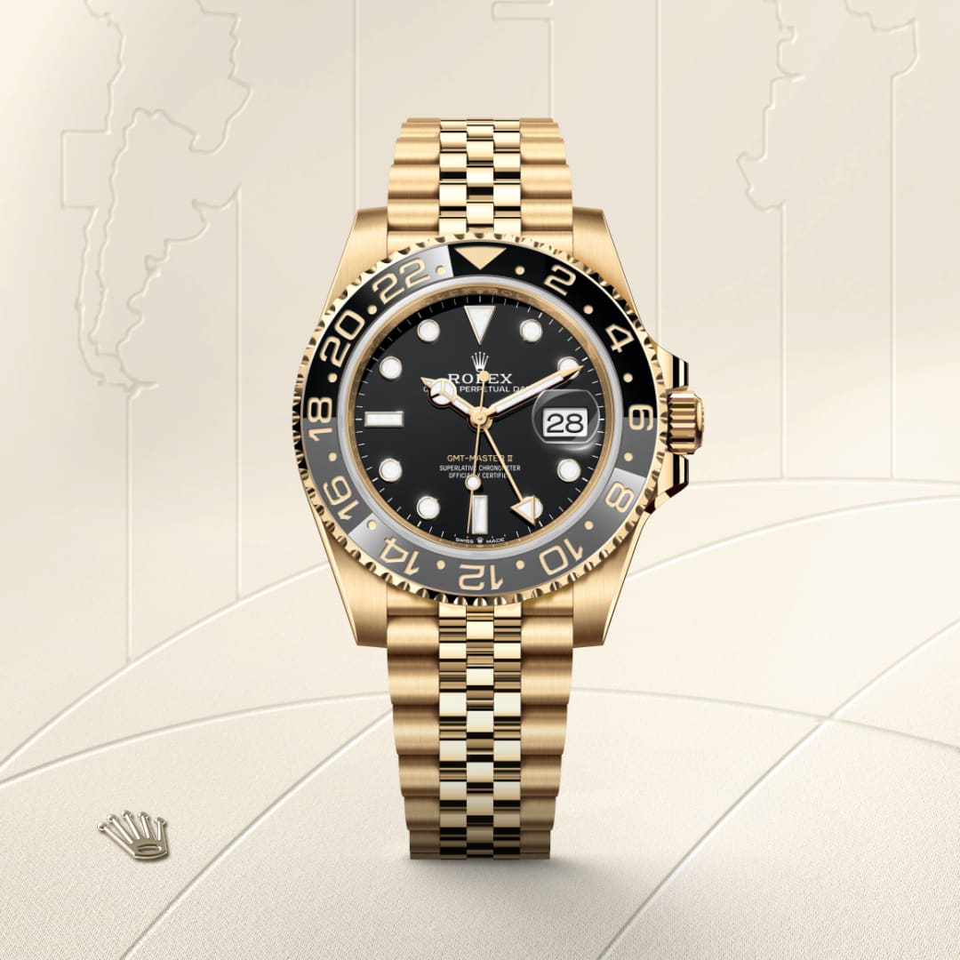 A gold Rolex watch with a black dial and date display, shown on a textured cream background.