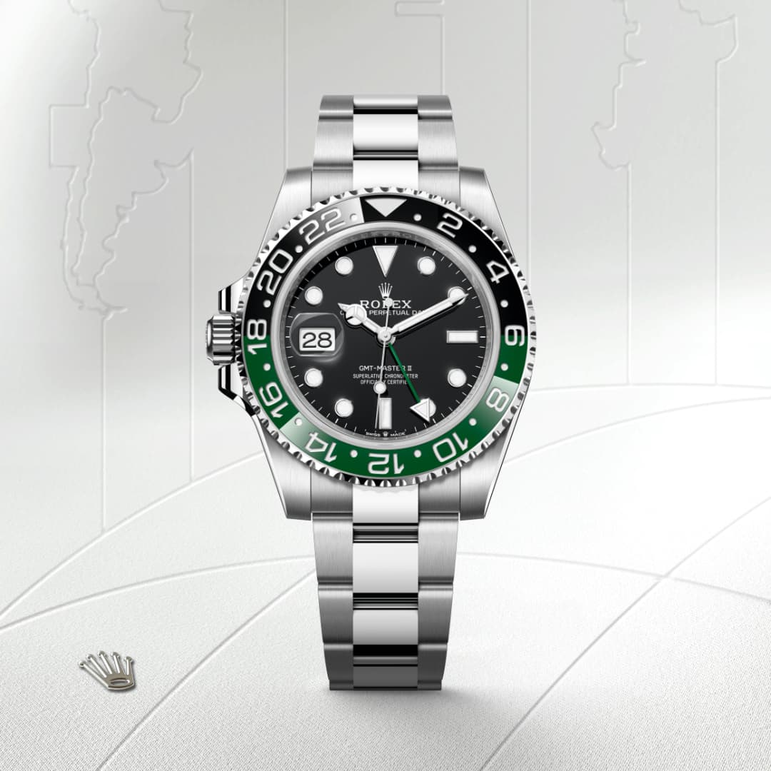 A silver Rolex GMT-Master II watch with a black and green bezel displayed on a light patterned background.