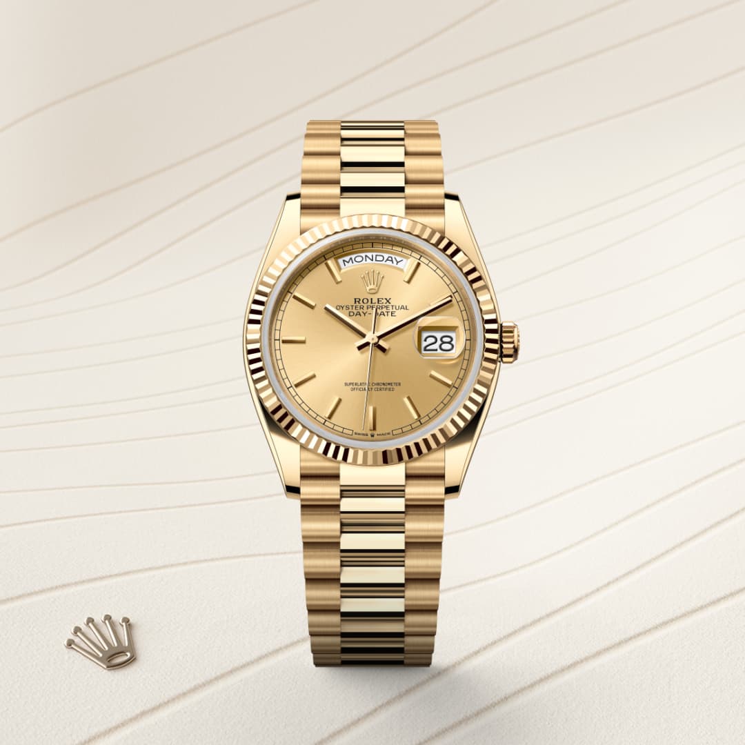 A gold Rolex wristwatch displays the day as Monday and the date as 28 on a textured beige background.