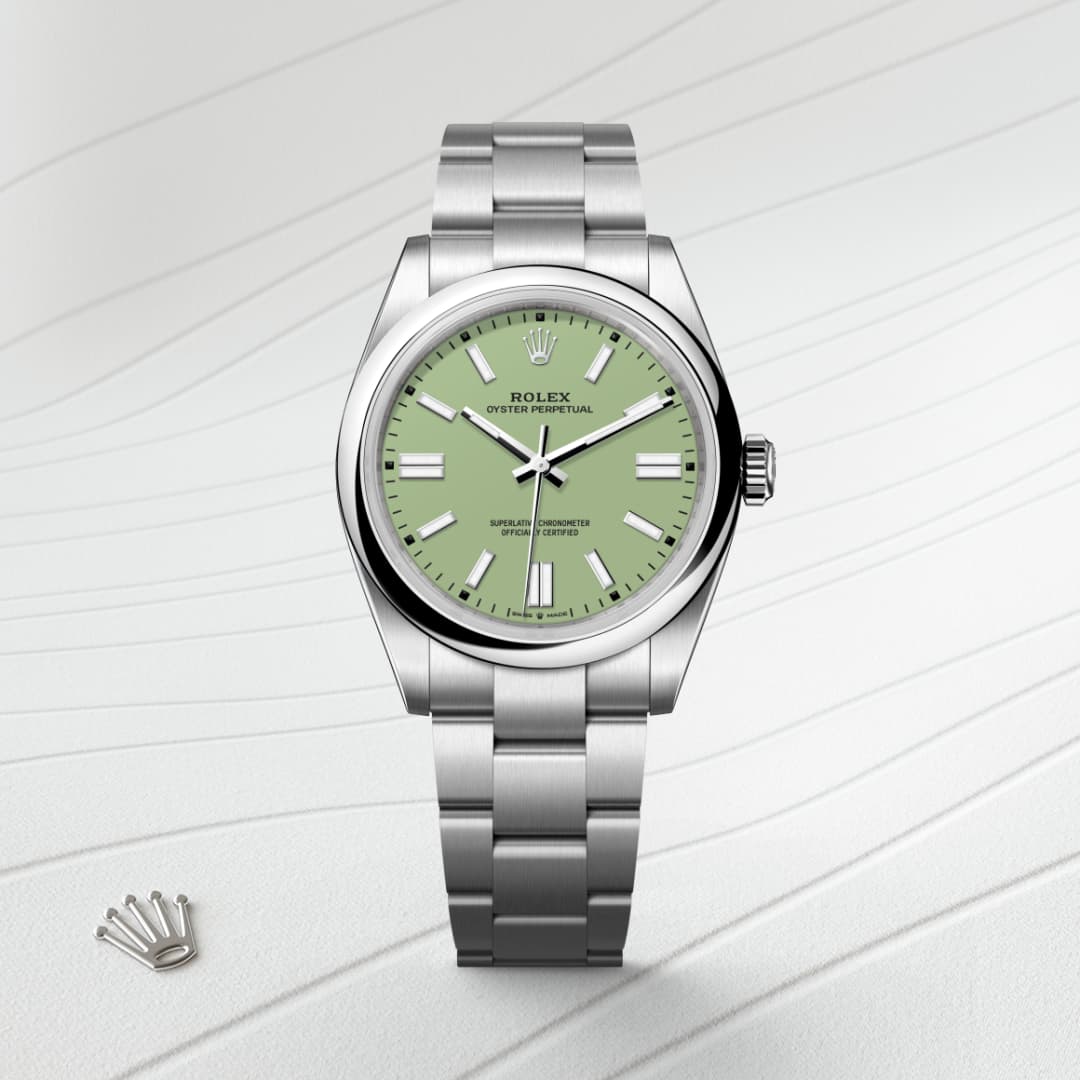 A silver Rolex watch with a green dial on a textured white background, next to a small Rolex crown logo.
