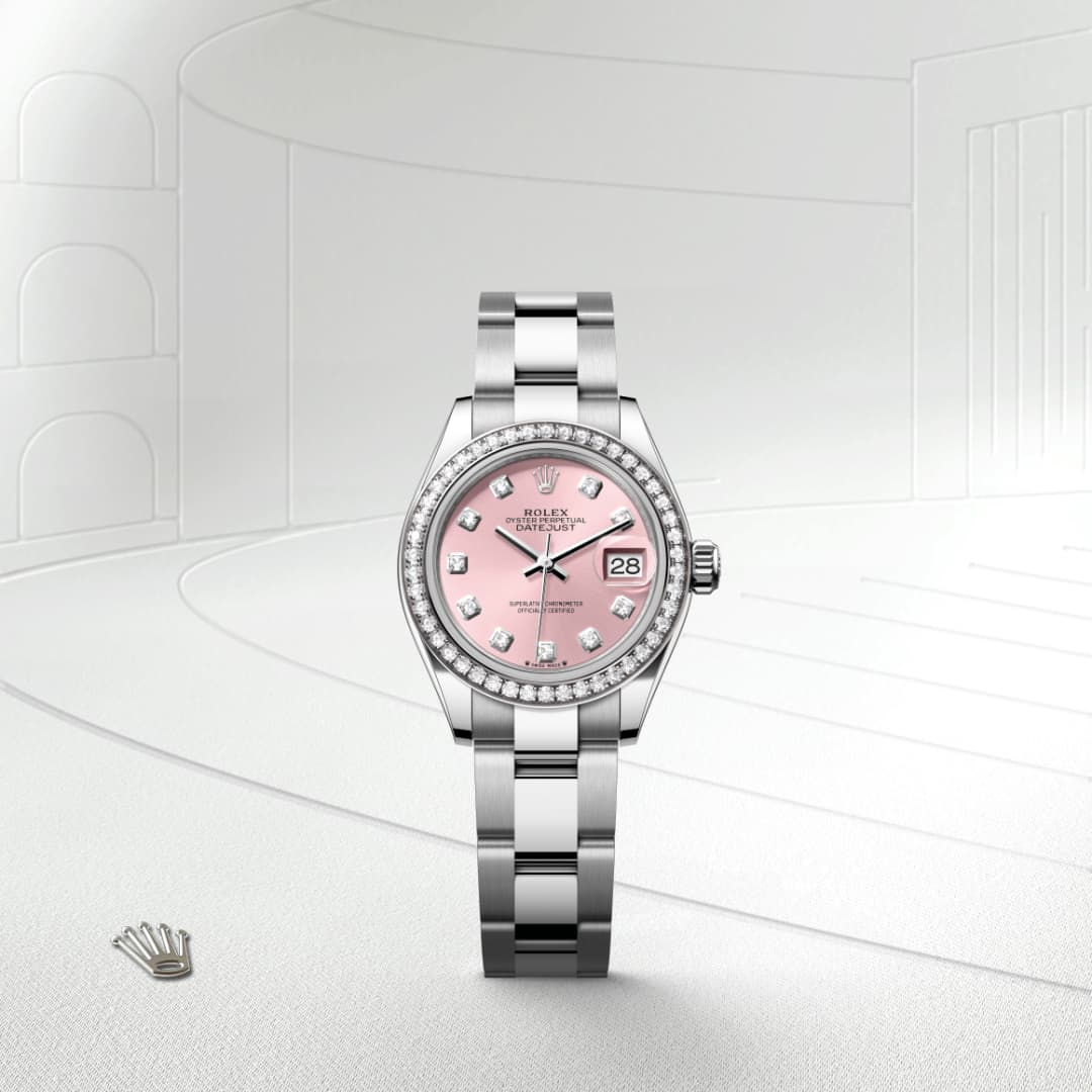 A silver Rolex watch with a pink dial and diamond bezel, displayed on a light, minimalist background.