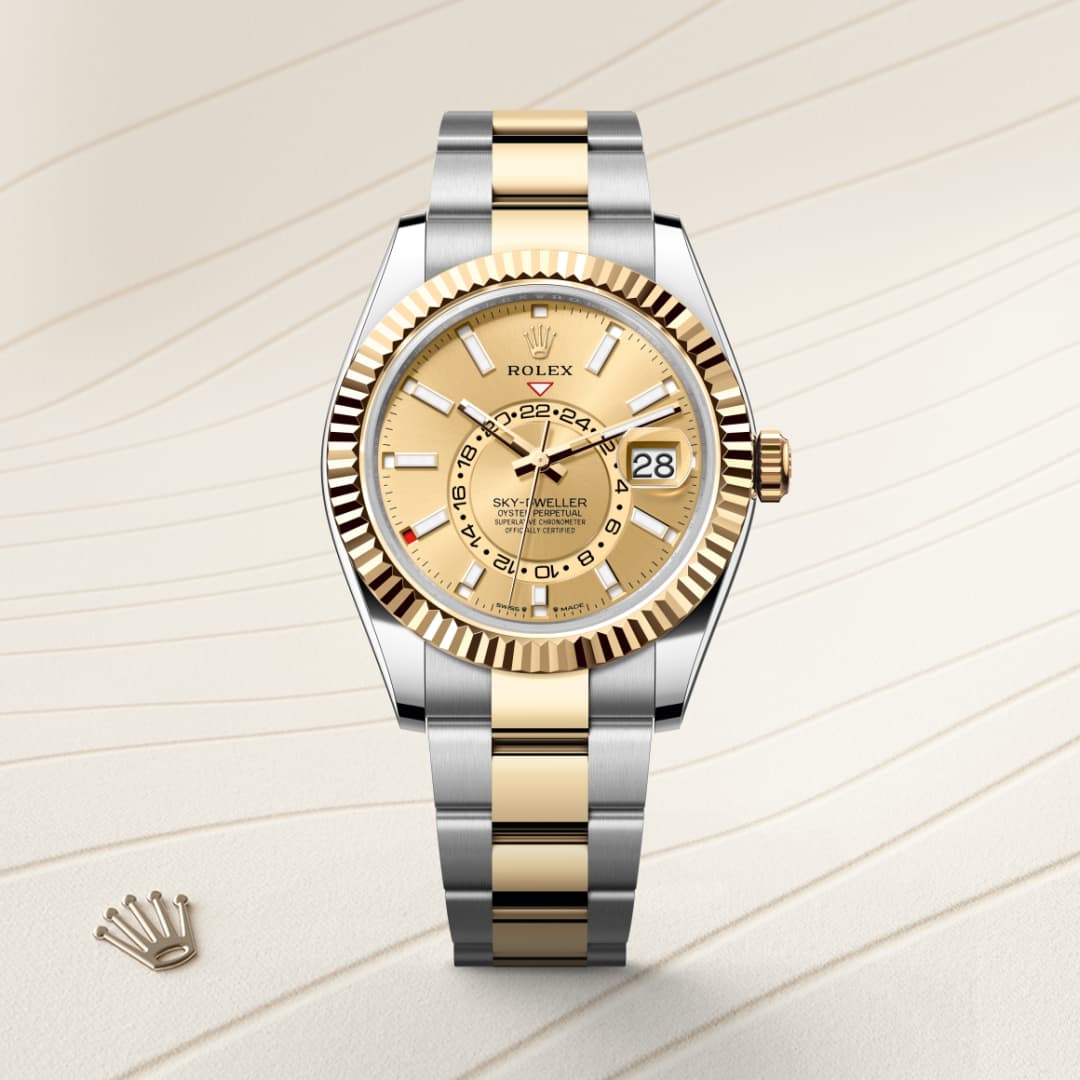 A gold and silver Rolex Sky-Dweller watch with a gold dial displayed on a light patterned background.