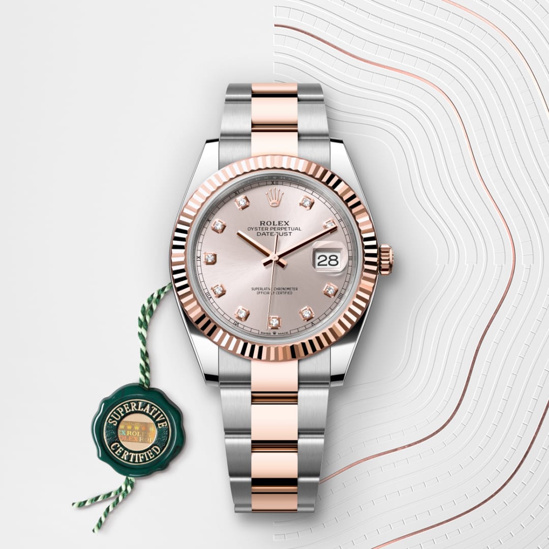 A two-tone Rolex Datejust watch with a silver and rose gold bracelet, displayed with a green certification tag.