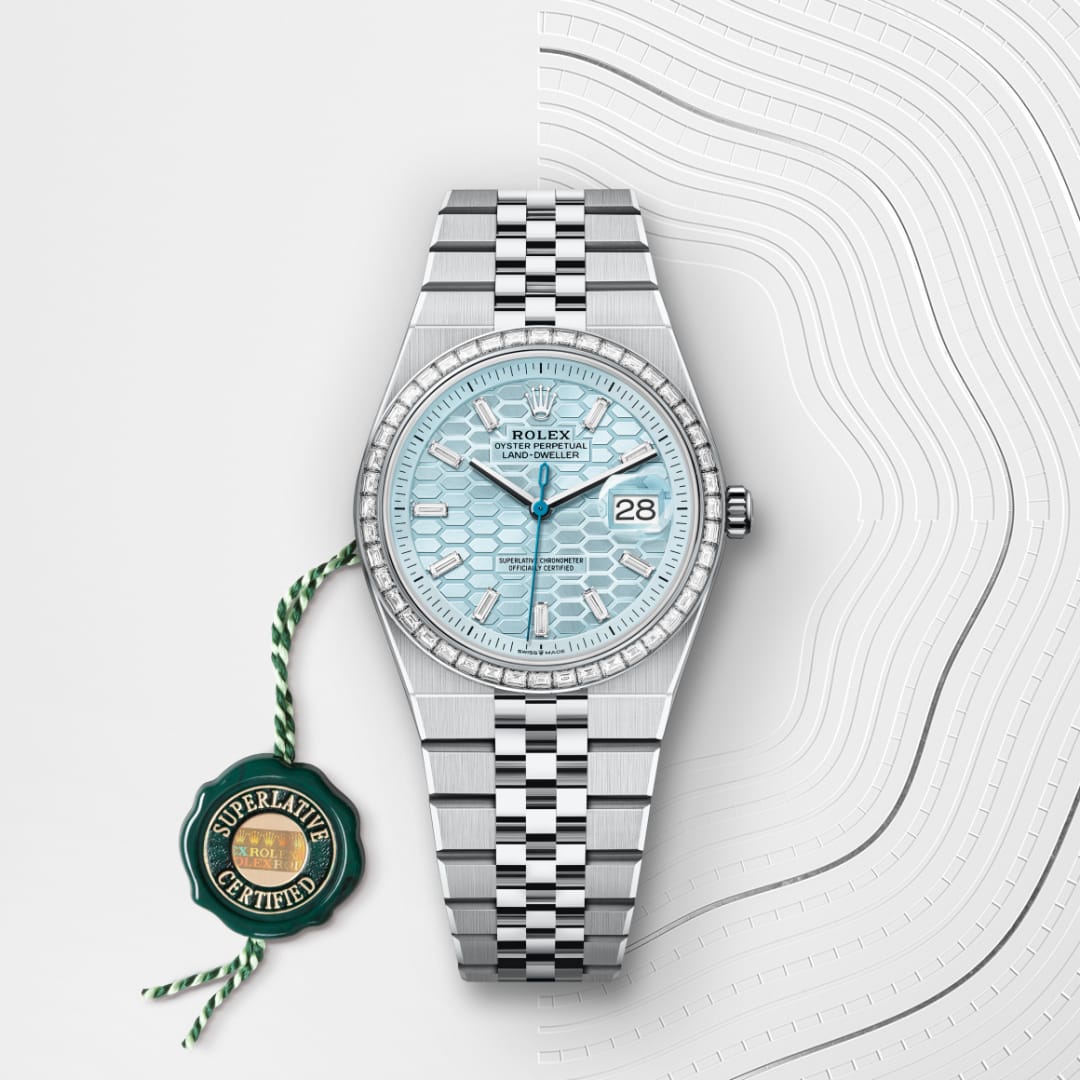 A silver Rolex watch with a light blue face and date display, placed on a textured white background.