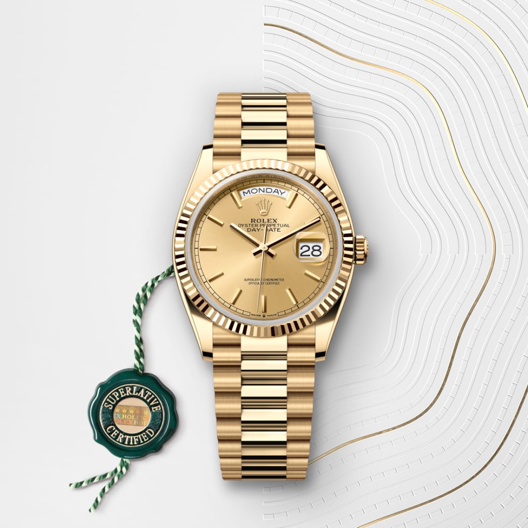 Gold Rolex watch showing Monday, 28th, displayed with a green Superlative Certified tag on a white background.