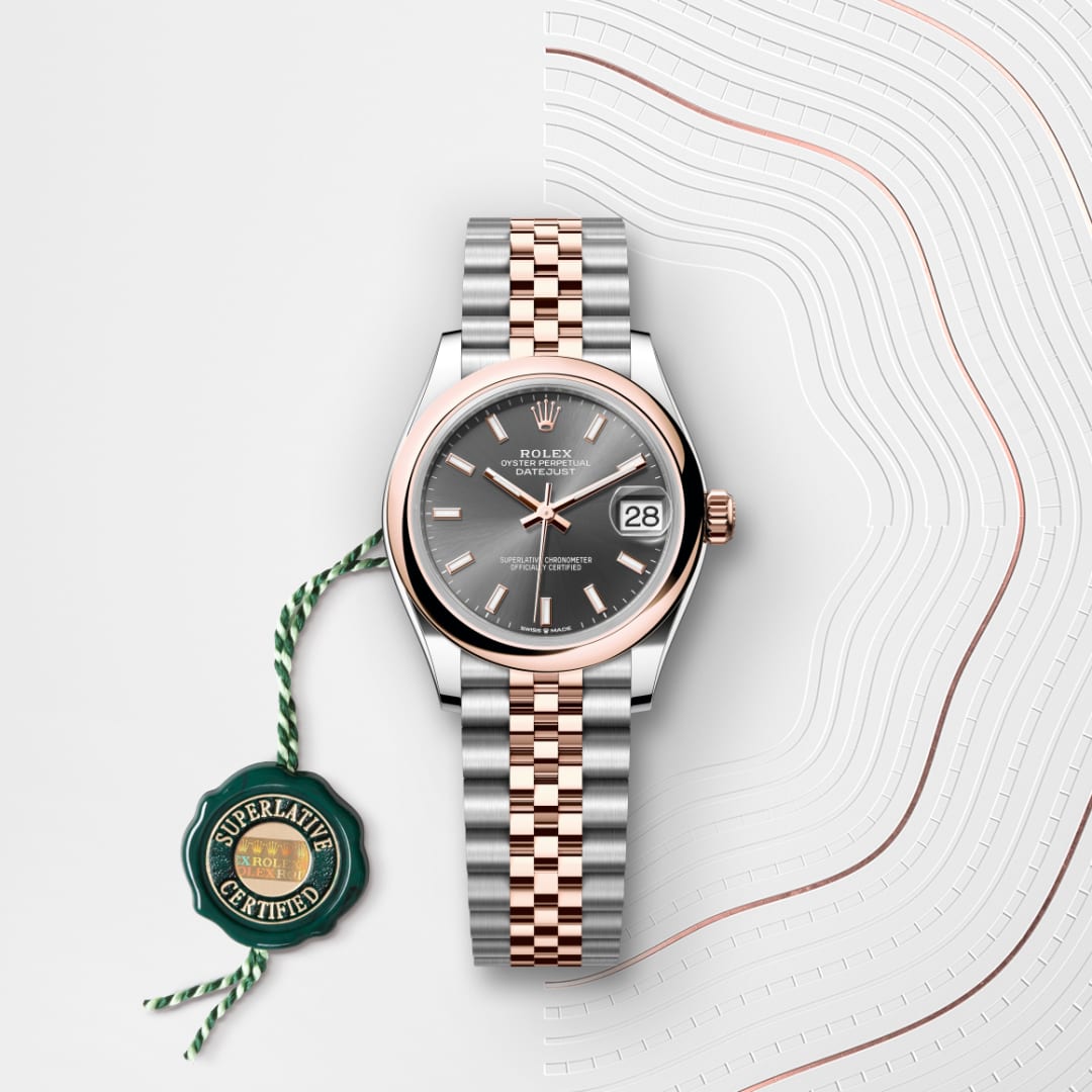 Two-tone Rolex watch with a black dial and date display, shown alongside a green Superlative Certified tag.