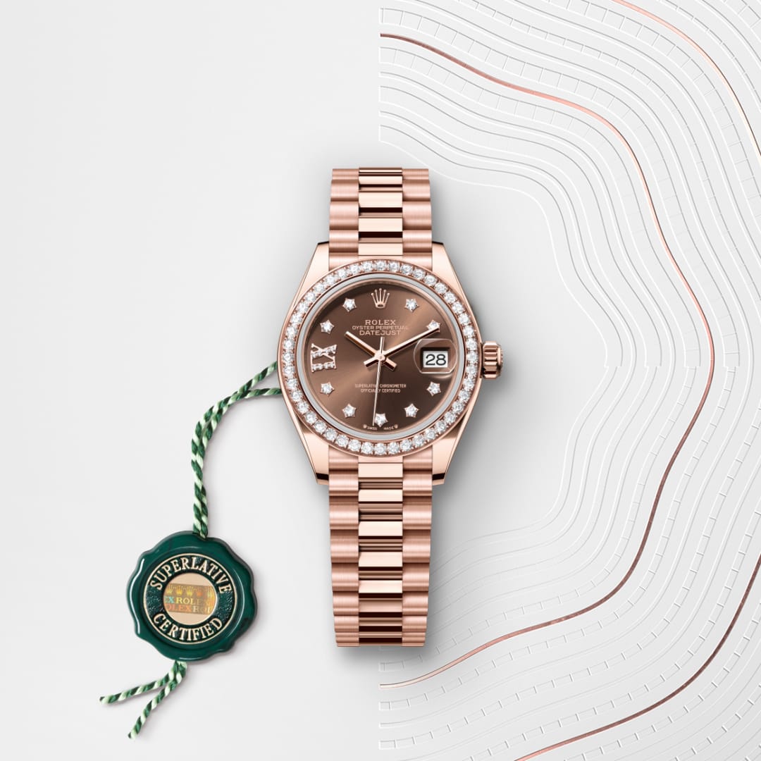 A rose gold Rolex watch with diamond markers and a green Superlative Certified tag on a patterned background.