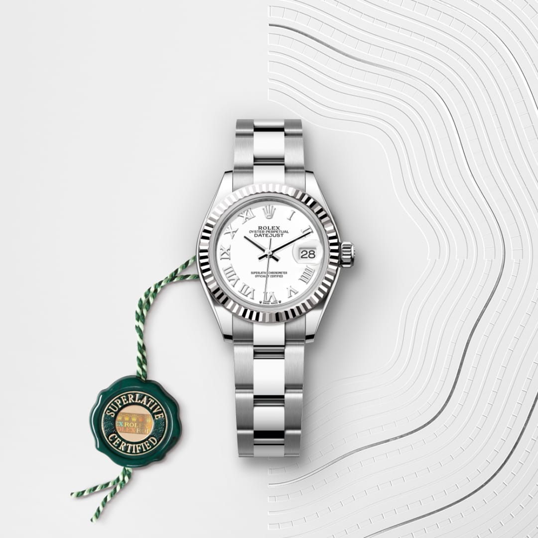 A silver Rolex watch with a white face and Roman numerals, next to a green Superlative Certified tag.