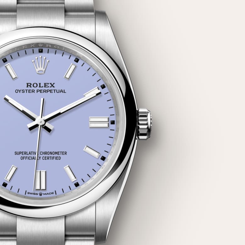 Close-up of a silver Rolex Oyster Perpetual watch with a light blue dial and silver hour markers.