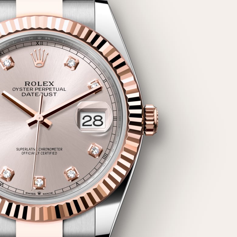 Close-up of a Rolex Oyster Perpetual Datejust watch with a silver dial and date display showing 28.