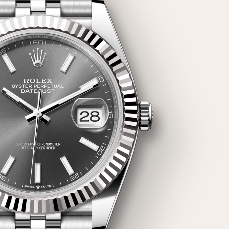 Close-up of a Rolex Datejust watch with a silver dial, date display, and stainless steel bracelet.