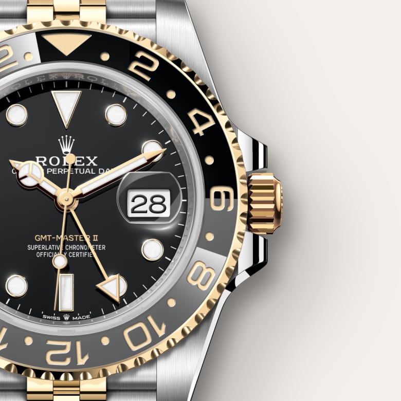 Close-up of a Rolex GMT-Master II watch with gold and black accents, showing the date as 28.