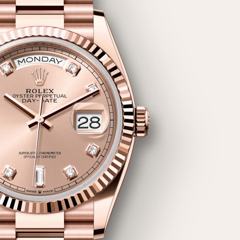 Close-up of a rose gold Rolex Day-Date watch showing the day, date, and diamond hour markers.