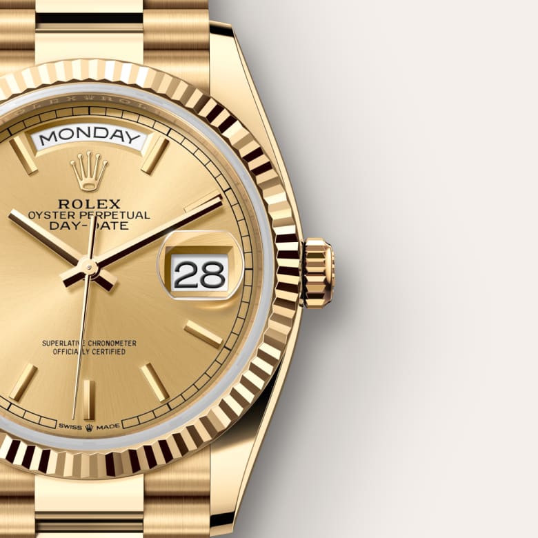 Gold Rolex watch showing Monday and the 28th, with a champagne dial and fluted bezel.