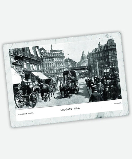 Black and white photo of Ludgate Hill, London, showing horse-drawn carriages and people on the street.
