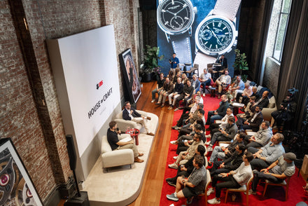 An audience seated in front of two speakers with a House of Craft - Hodinkee title behind them