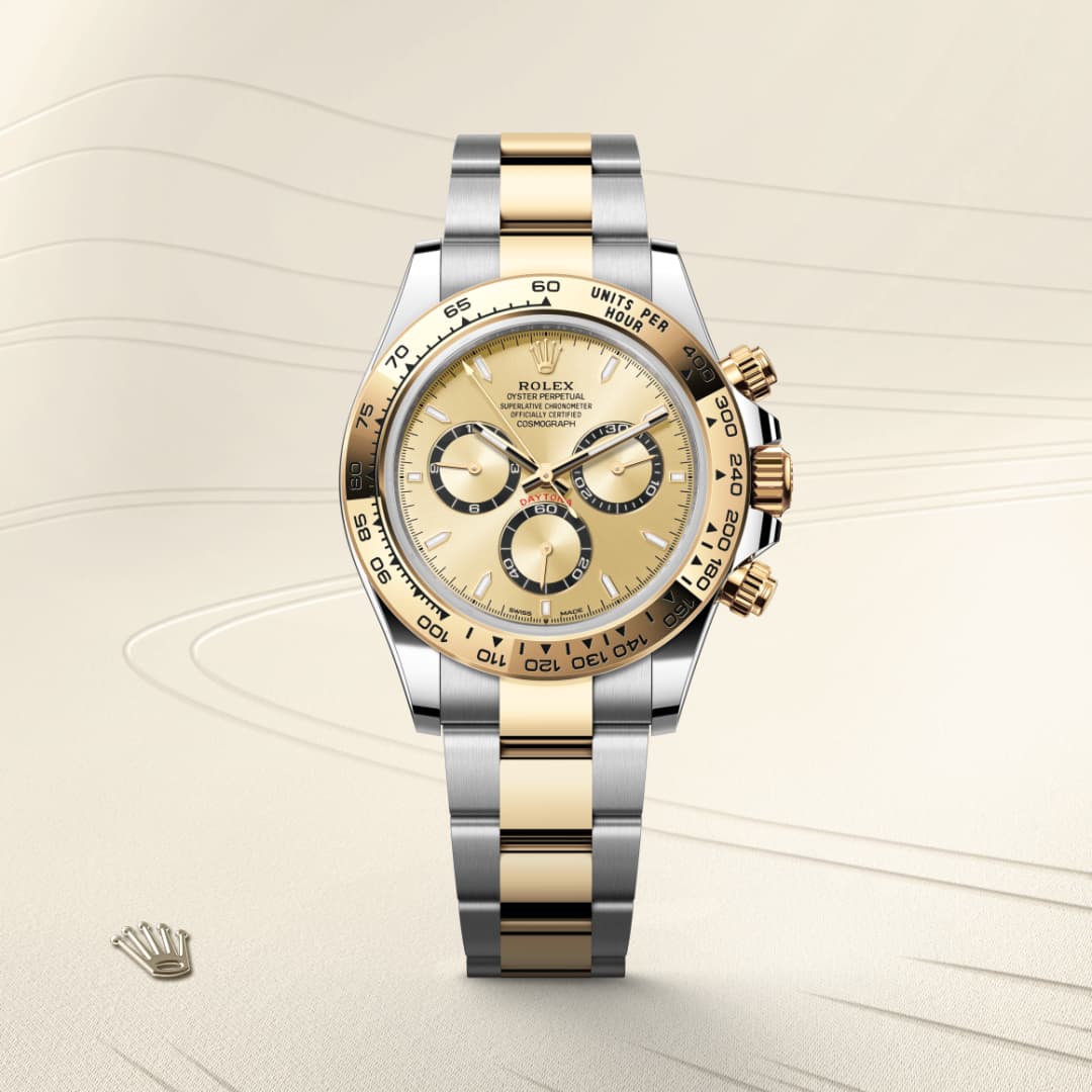 A two-tone gold and silver Rolex watch with a champagne dial, three subdials, and a metal bracelet.