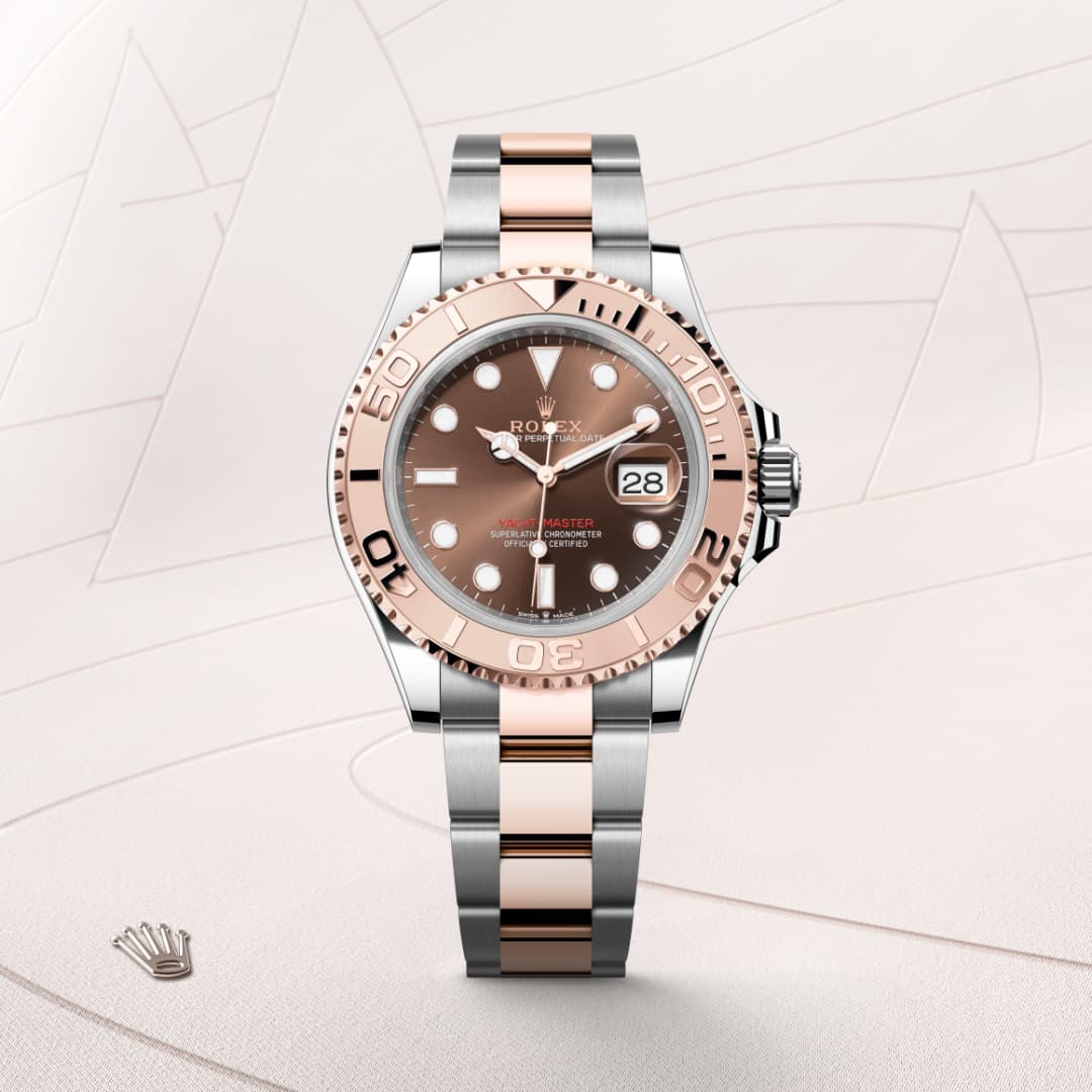 A Rolex watch with a brown dial, rose gold bezel, and two-tone silver and rose gold bracelet on a pale background.
