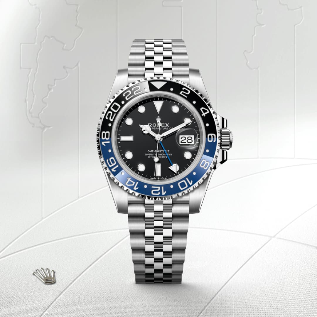 A Rolex GMT-Master II watch with a black and blue bezel, black dial, and silver jubilee bracelet against a map background.