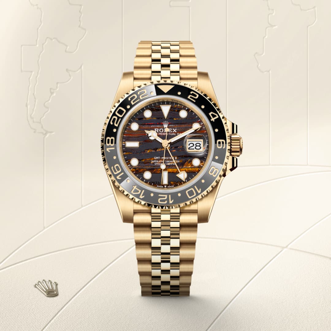 Gold Rolex watch with a patterned face, date display, and a black bezel, shown on a cream background.