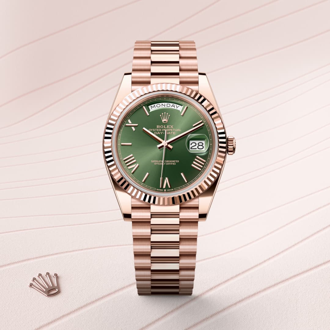 A rose gold Rolex watch with a green dial and Roman numerals, displayed on a pale, wavy patterned background.