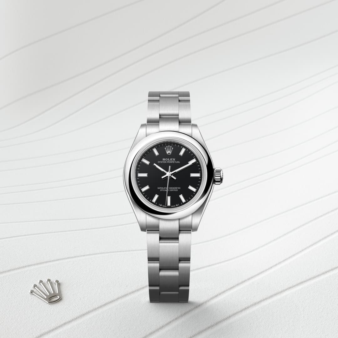 A silver Rolex wristwatch with a black dial, displayed upright on a textured white background.