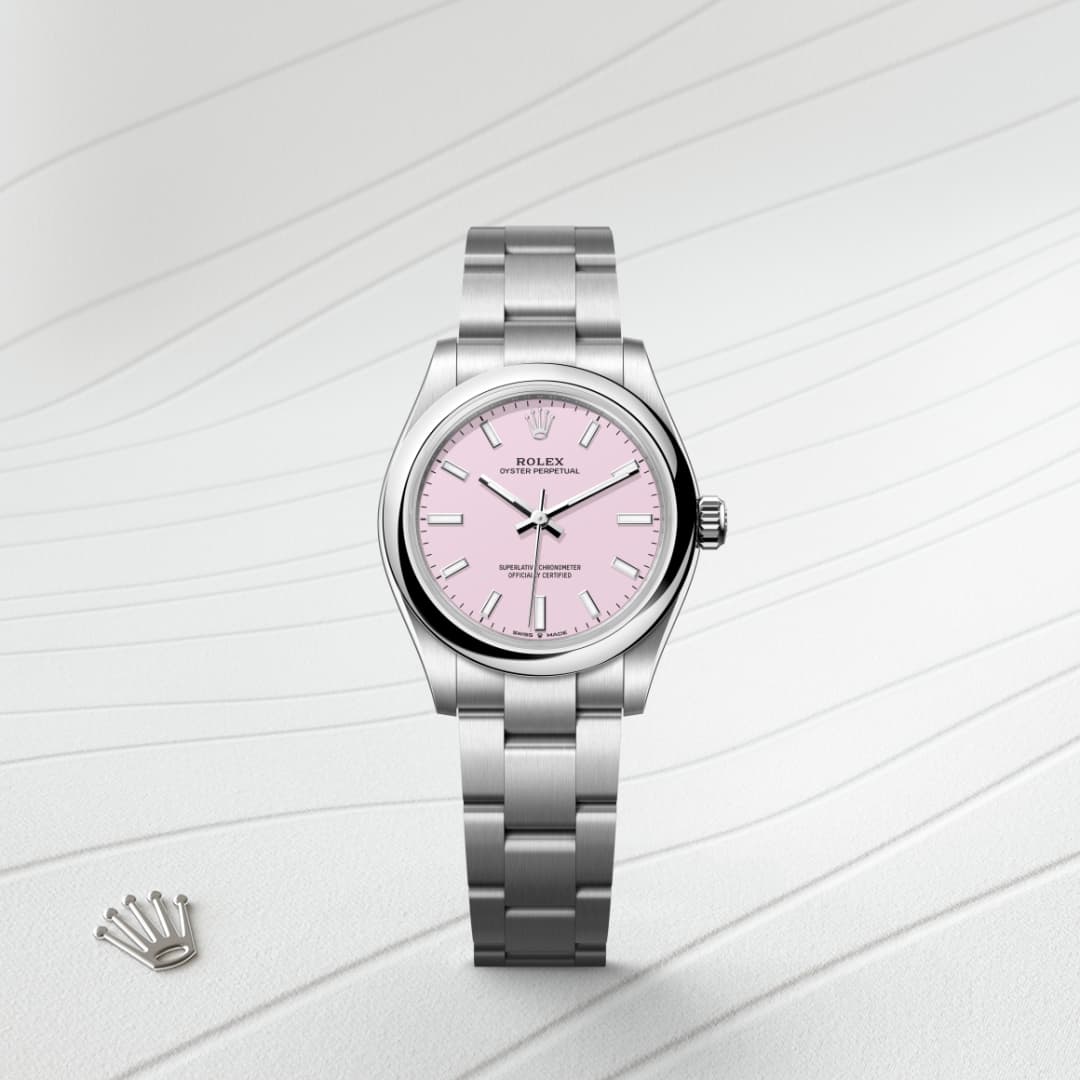 A silver Rolex watch with a pink dial on a textured white background, with a small crown emblem nearby.