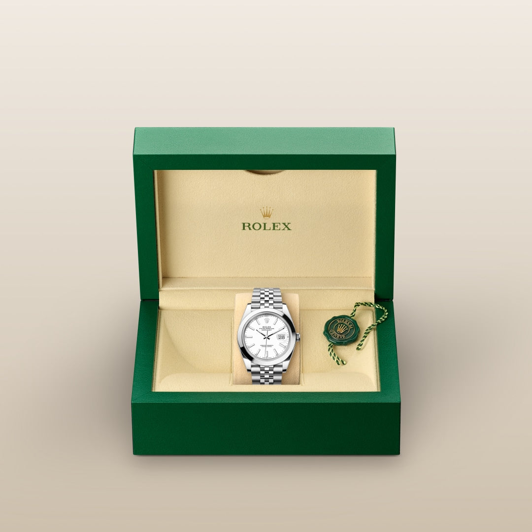 A Rolex watch with a silver bracelet displayed in an open green and beige Rolex box.