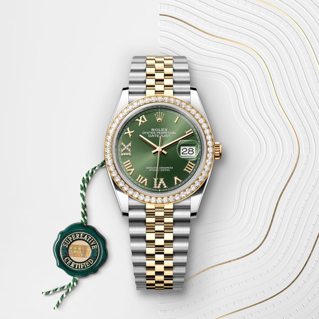 A Rolex Datejust watch with a green dial, diamond bezel, gold and silver band, and certification tag beside it.