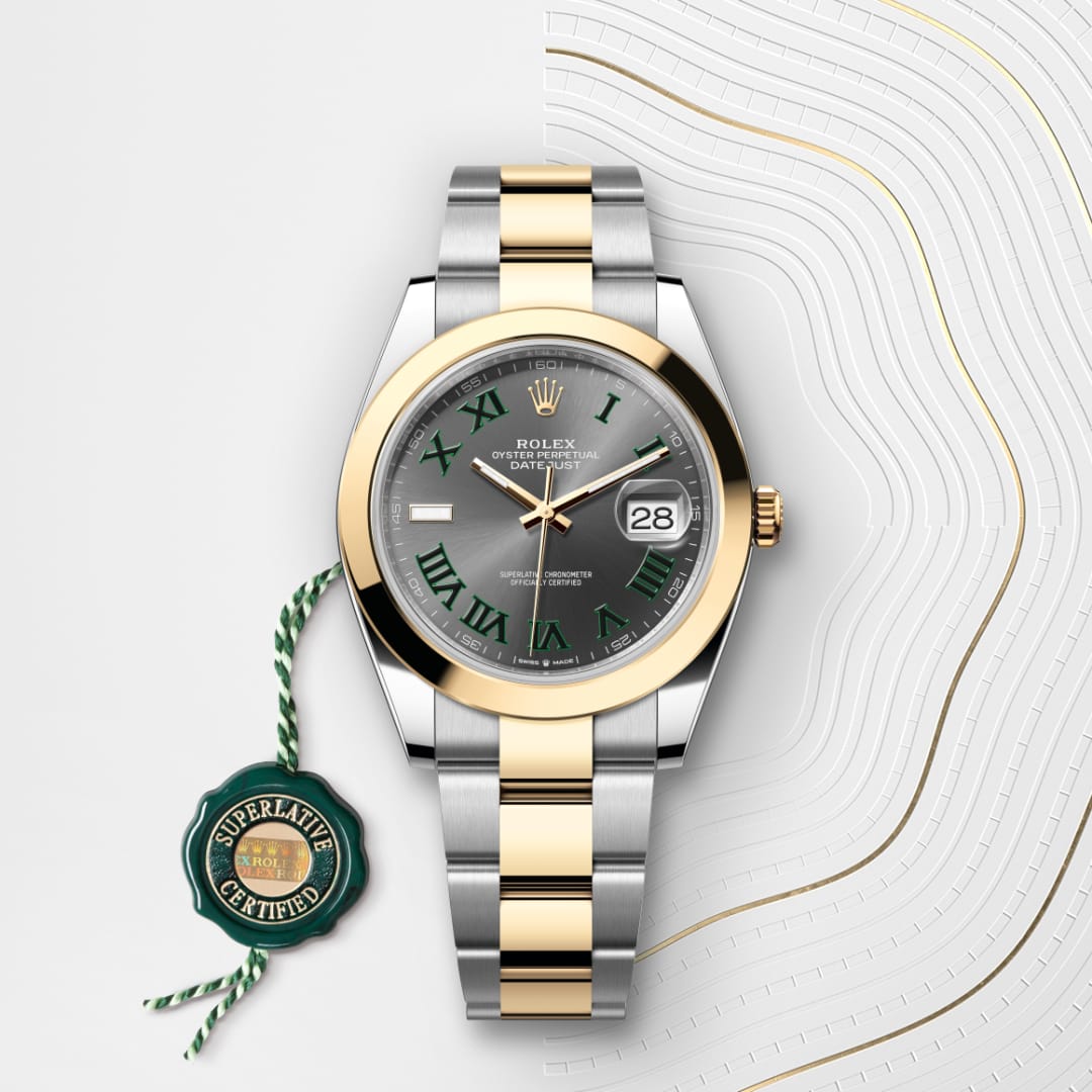 A Rolex watch with a gold and silver band, green Roman numerals, and a Superlative Certified tag beside it.