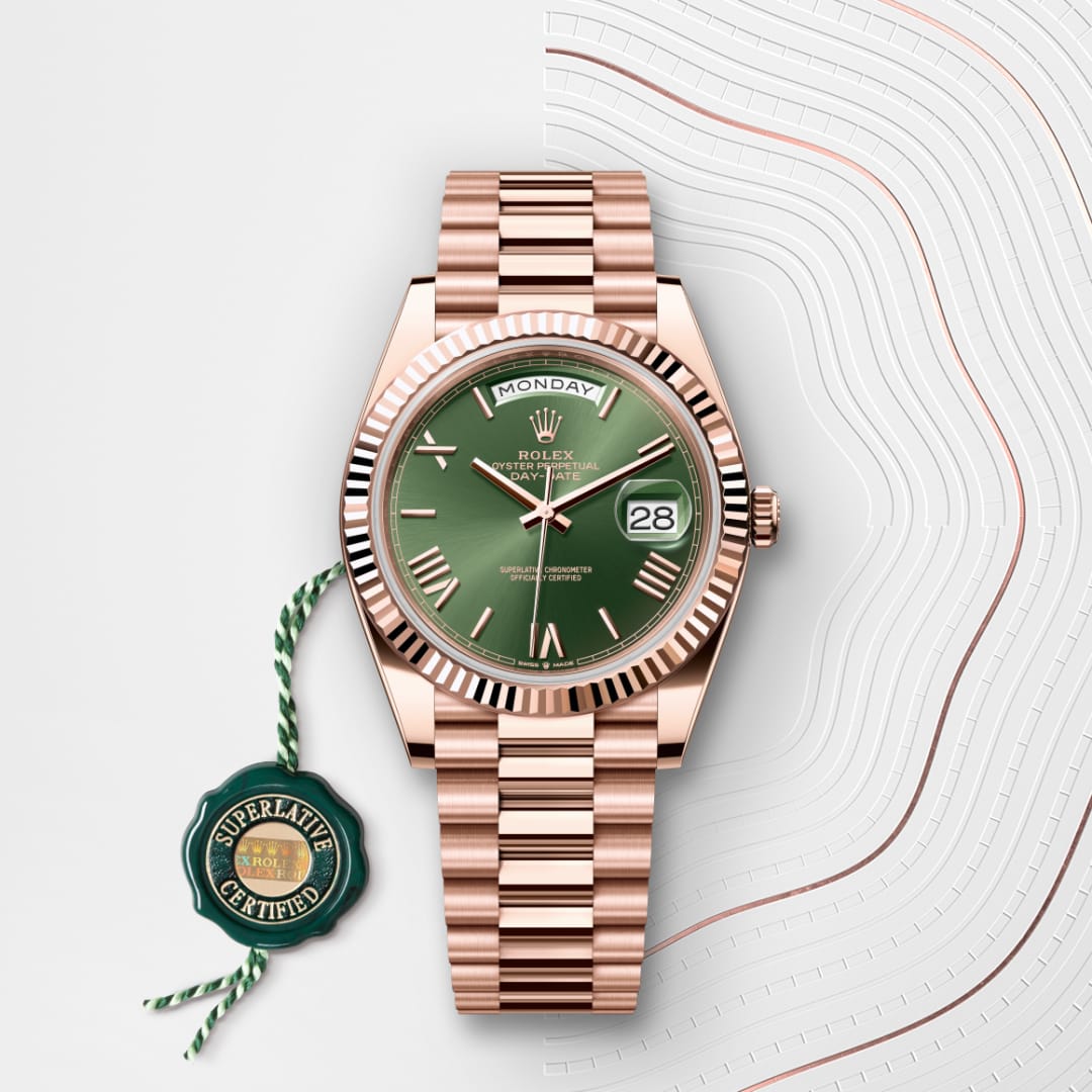 A rose gold Rolex watch with a green dial, day and date display, and a Superlative Certified tag.