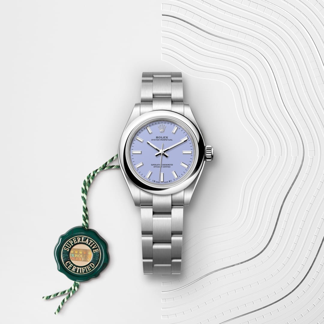 A silver Rolex watch with a light blue face and certification tag on a white, wavy lined background.