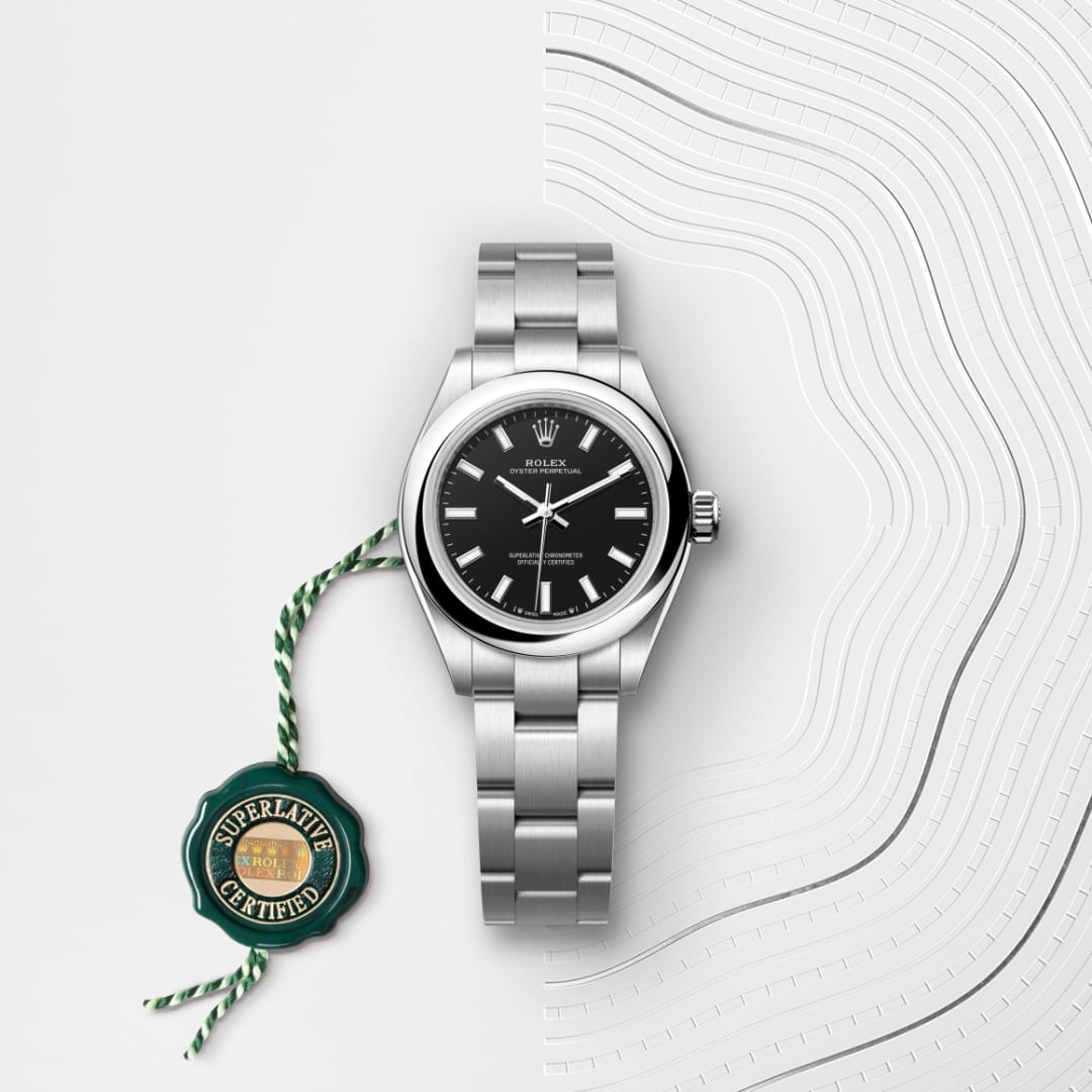 A silver Rolex watch with black dial and a green “Superlative Certified” tag on a textured white background.