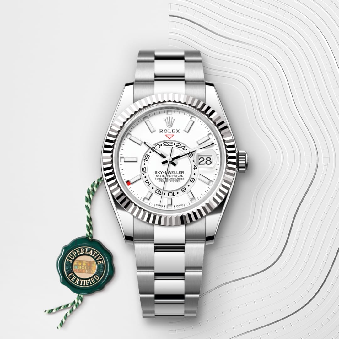 A silver Rolex Sky-Dweller watch with a white dial and a green Superlative Certified tag on a patterned background.