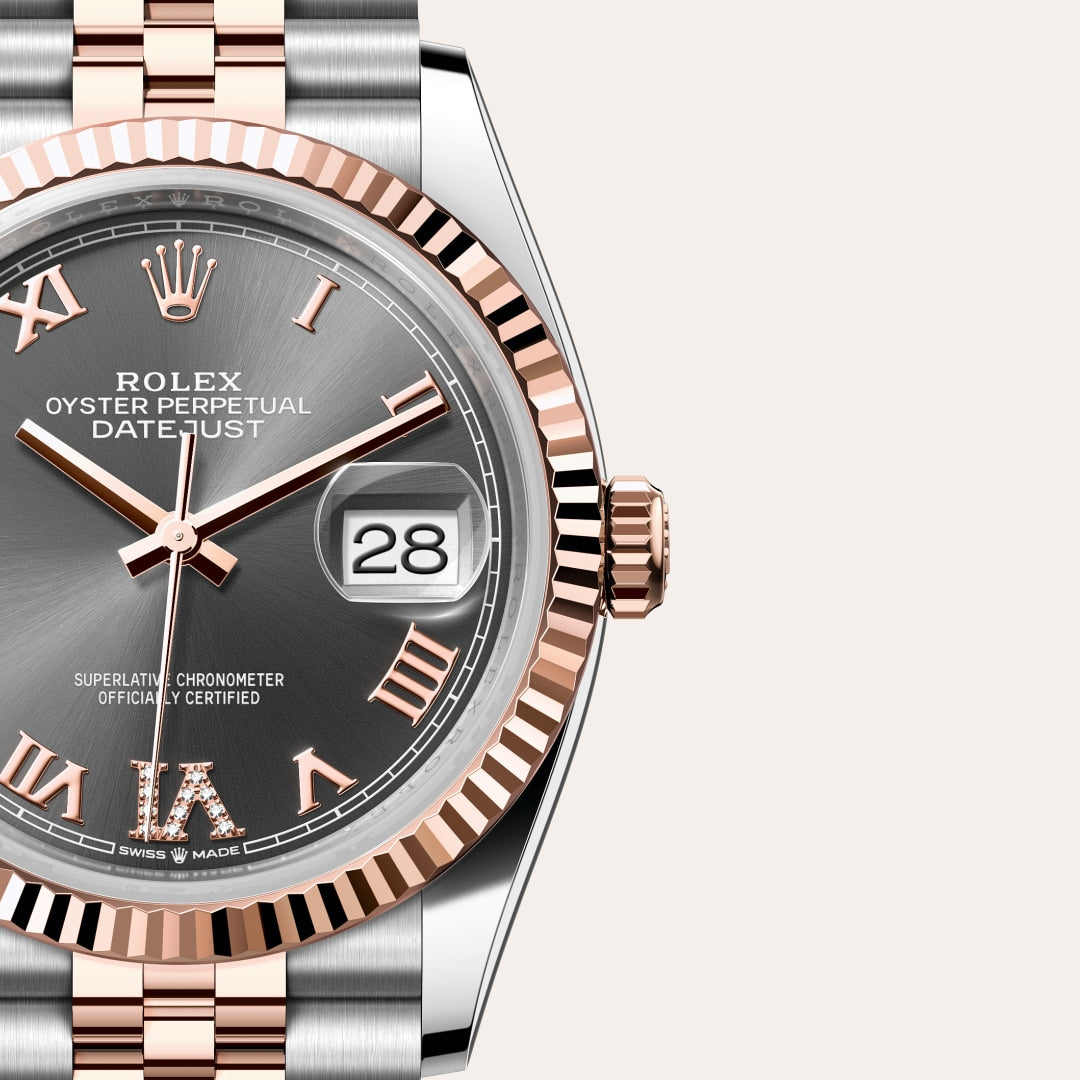 Close-up of a Rolex Datejust watch with a gray dial, rose gold accents, and date display at 3 oclock.