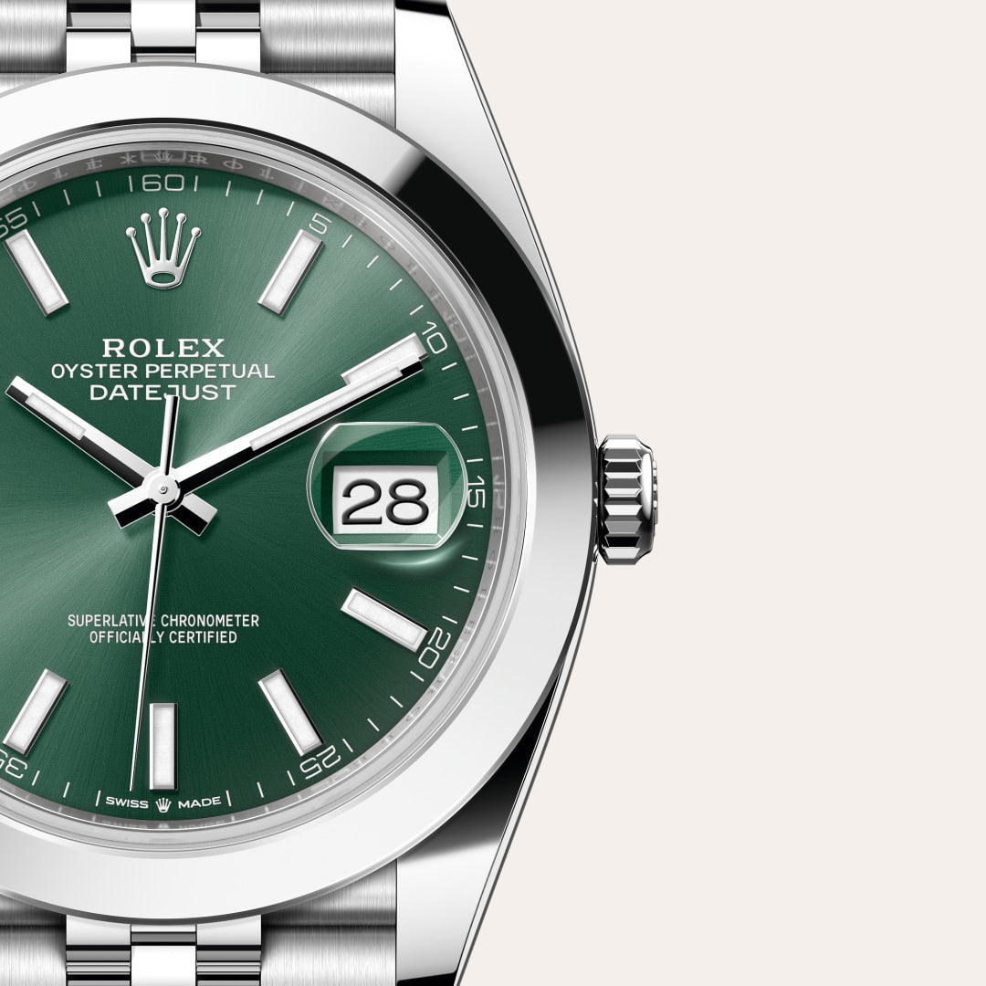 Close-up of a Rolex Oyster Perpetual Datejust watch with a green dial and the date set to 28.