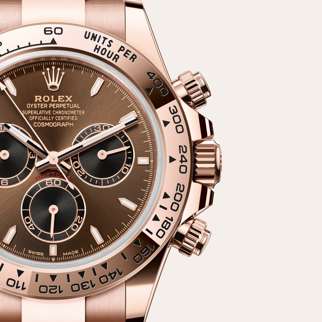 Close-up of a rose gold Rolex Cosmograph Daytona watch with a brown dial and three subdials.