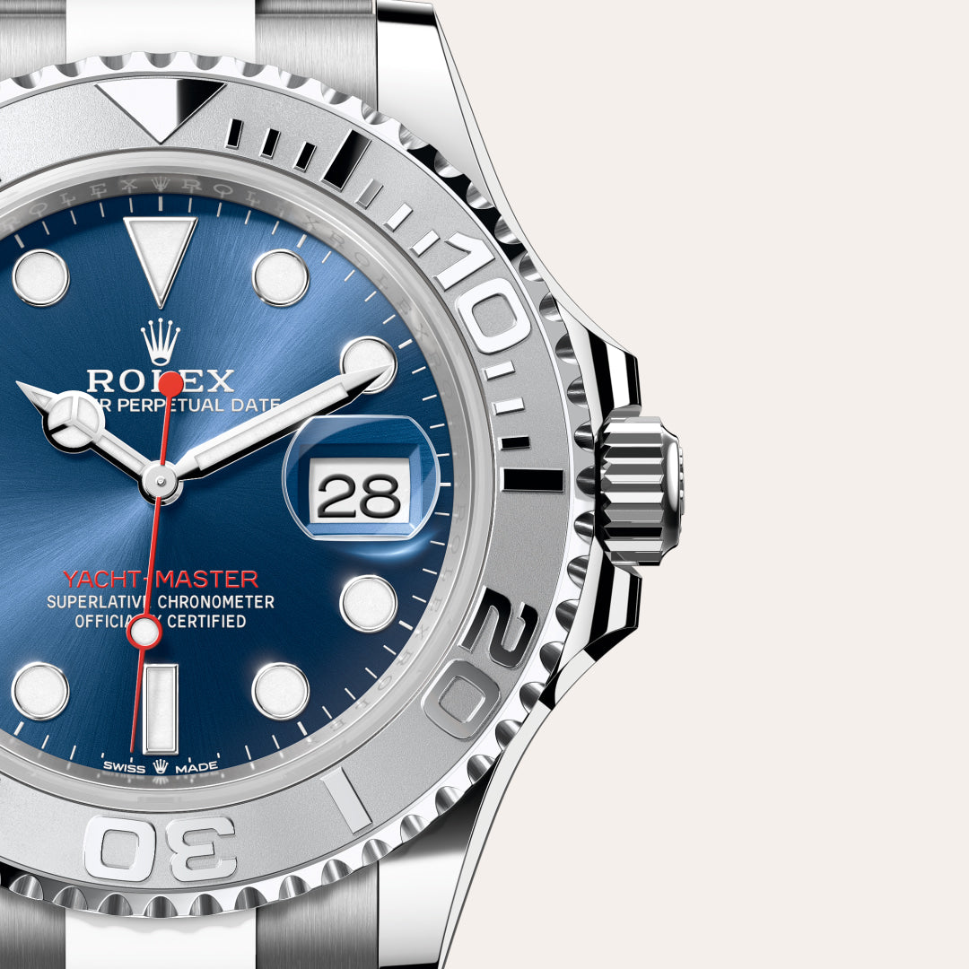 Close-up of a Rolex Yacht-Master watch with a blue dial, silver bezel, and the date displayed as 28.