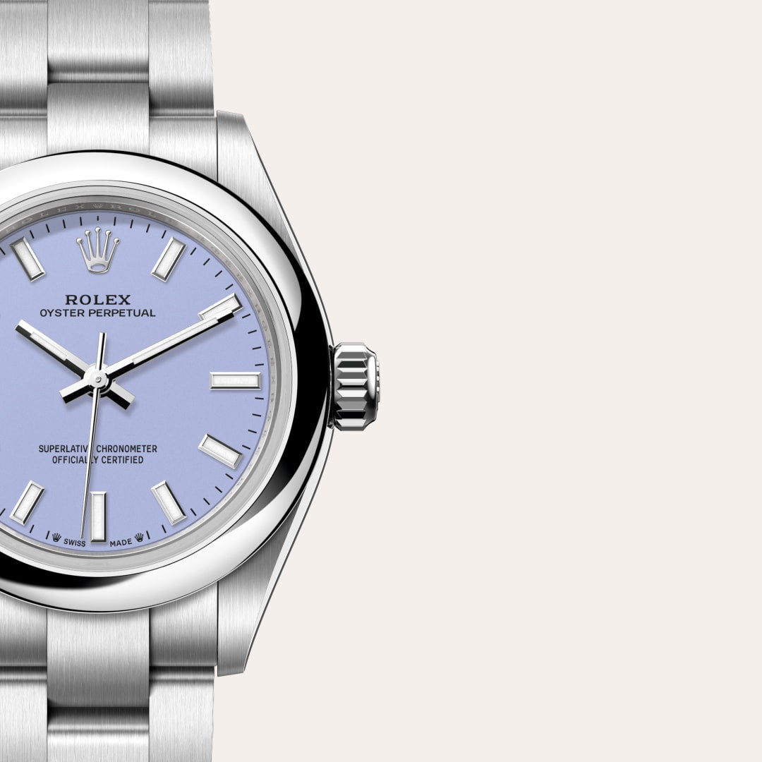 Close-up of a silver Rolex Oyster Perpetual watch with a light blue dial on a stainless steel bracelet.