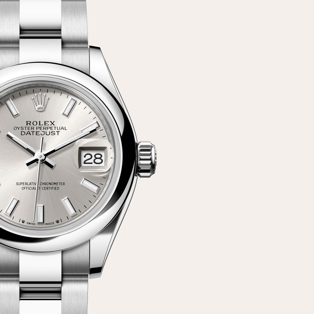 Close-up of a Rolex Oyster Perpetual Datejust watch with a silver dial and date display at 3 oclock.