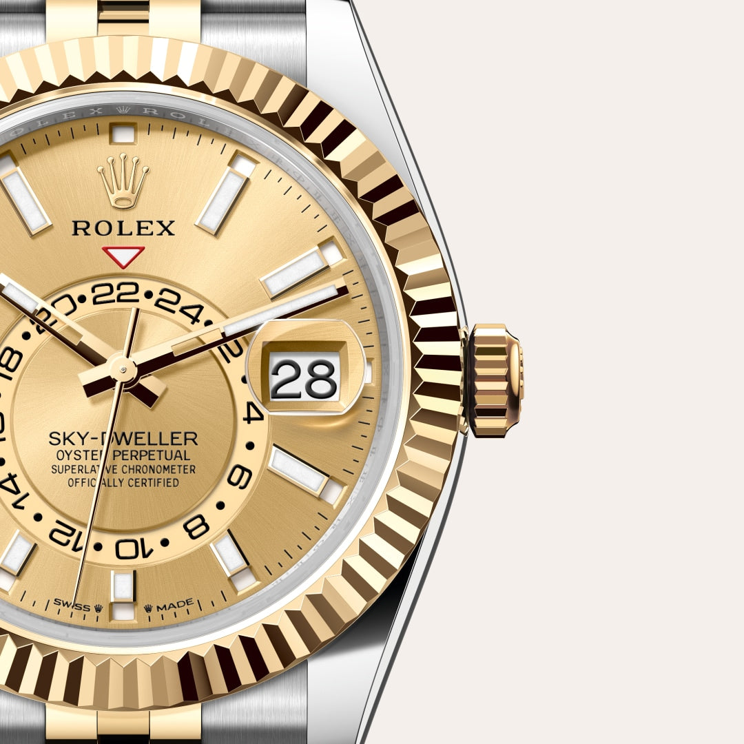 Close-up of a gold Rolex Sky-Dweller watch face displaying the date and time, with a fluted bezel.