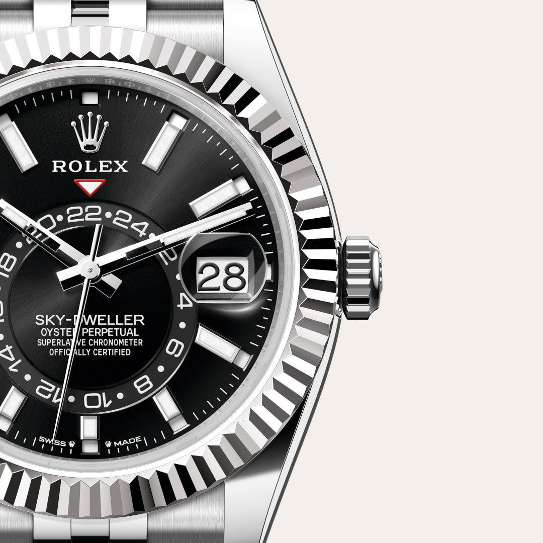 Close-up of a Rolex Sky-Dweller watch with a black dial, date display, and silver bezel.