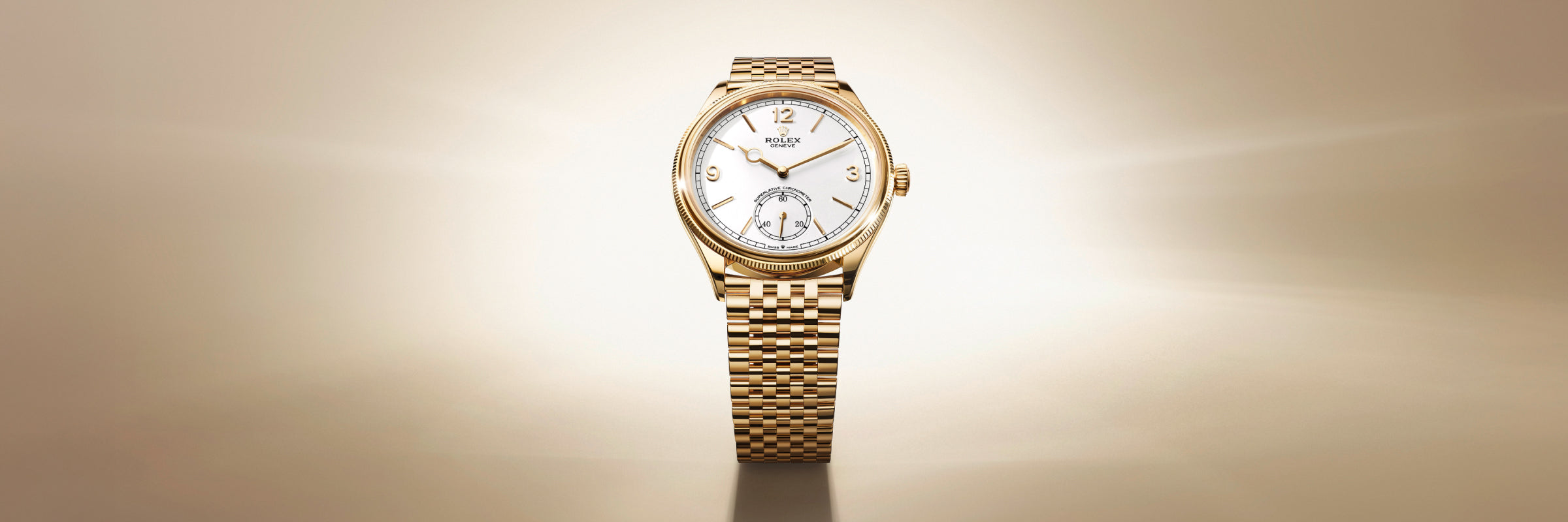 Gold Rolex wristwatch with a white dial on a matching gold bracelet, set against a light gradient background.
