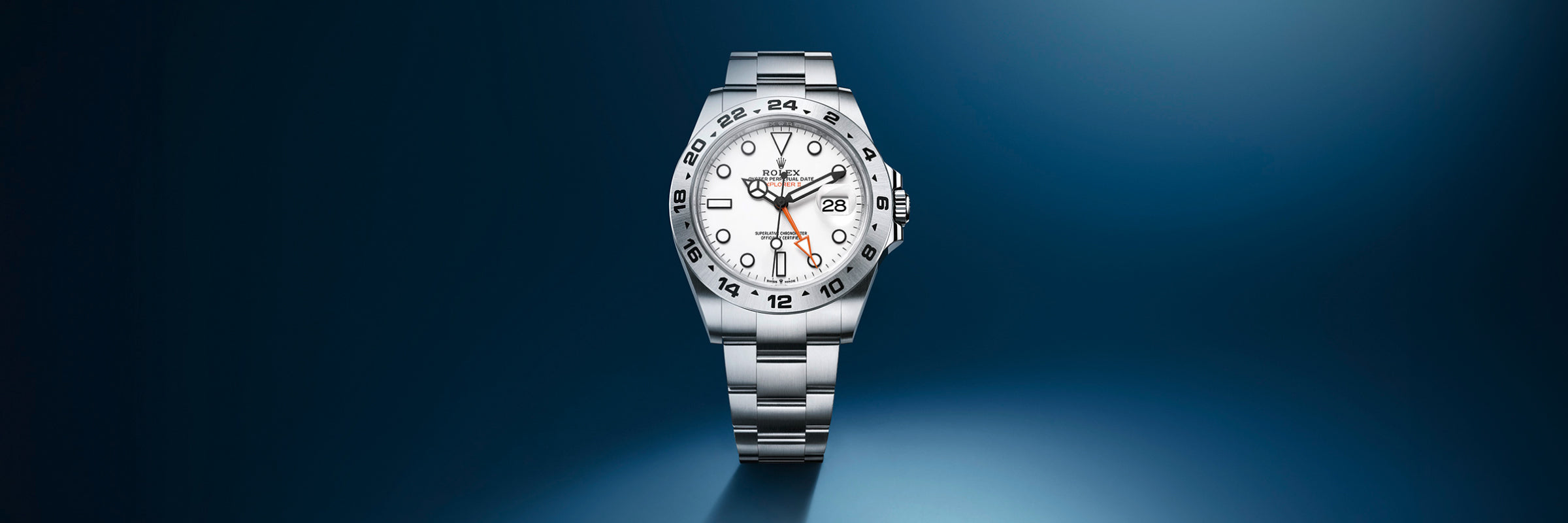 Silver luxury wristwatch with a white dial and metal band displayed on a gradient blue background.
