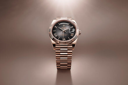 A Rolex Day-Date with a black dial and date display, showcased against a soft brown background.