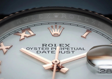 Close-up of a Rolex watch face showing Roman numerals, gold hands, crown logo, and date window.